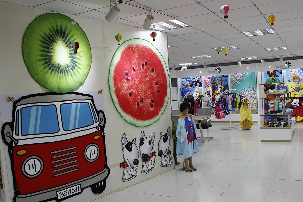Round fruit-print towels and a van-shaped towel displayed in the showroom