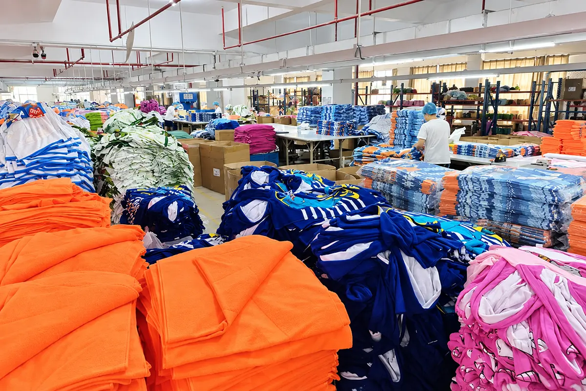 Colorful towel batches stacked by sewing and finishing workstations