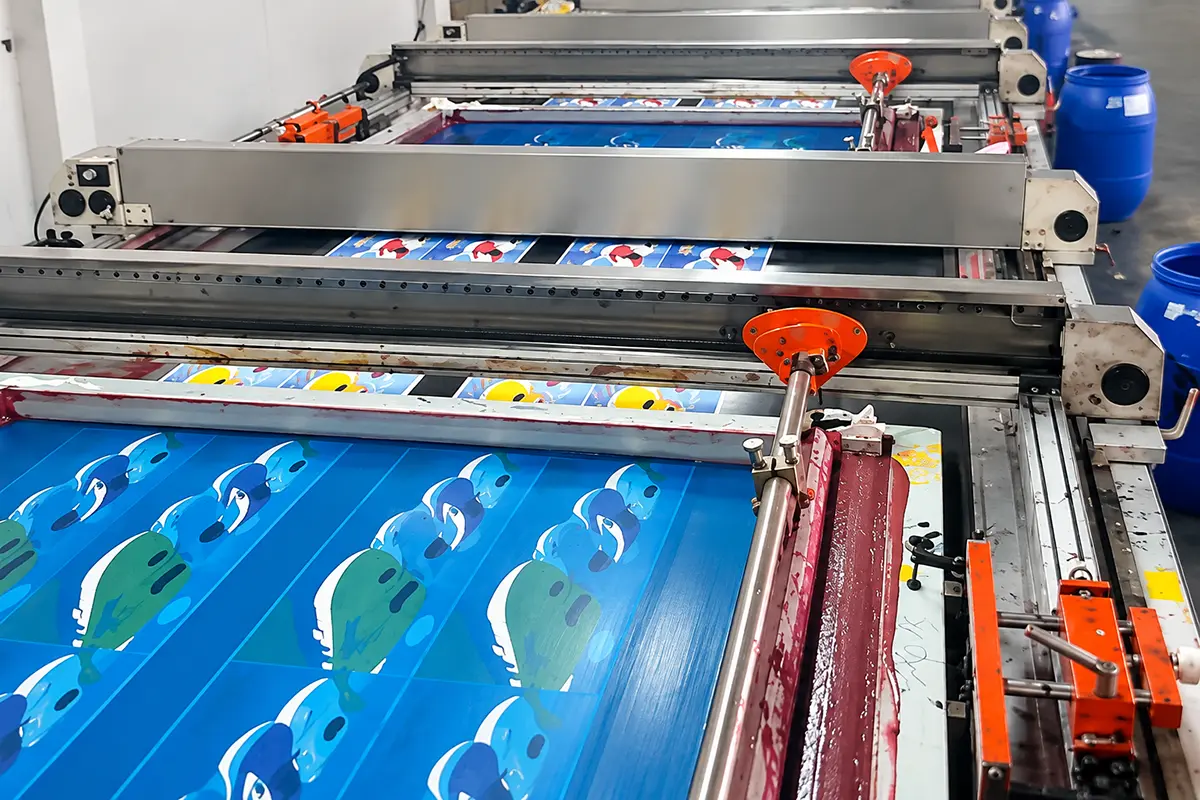 Screen-printing equipment applying colorful designs to towel fabric
