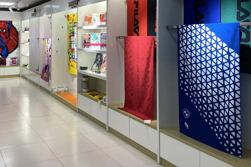 Hanging towel samples with geometric patterns, solid colors and printed designs