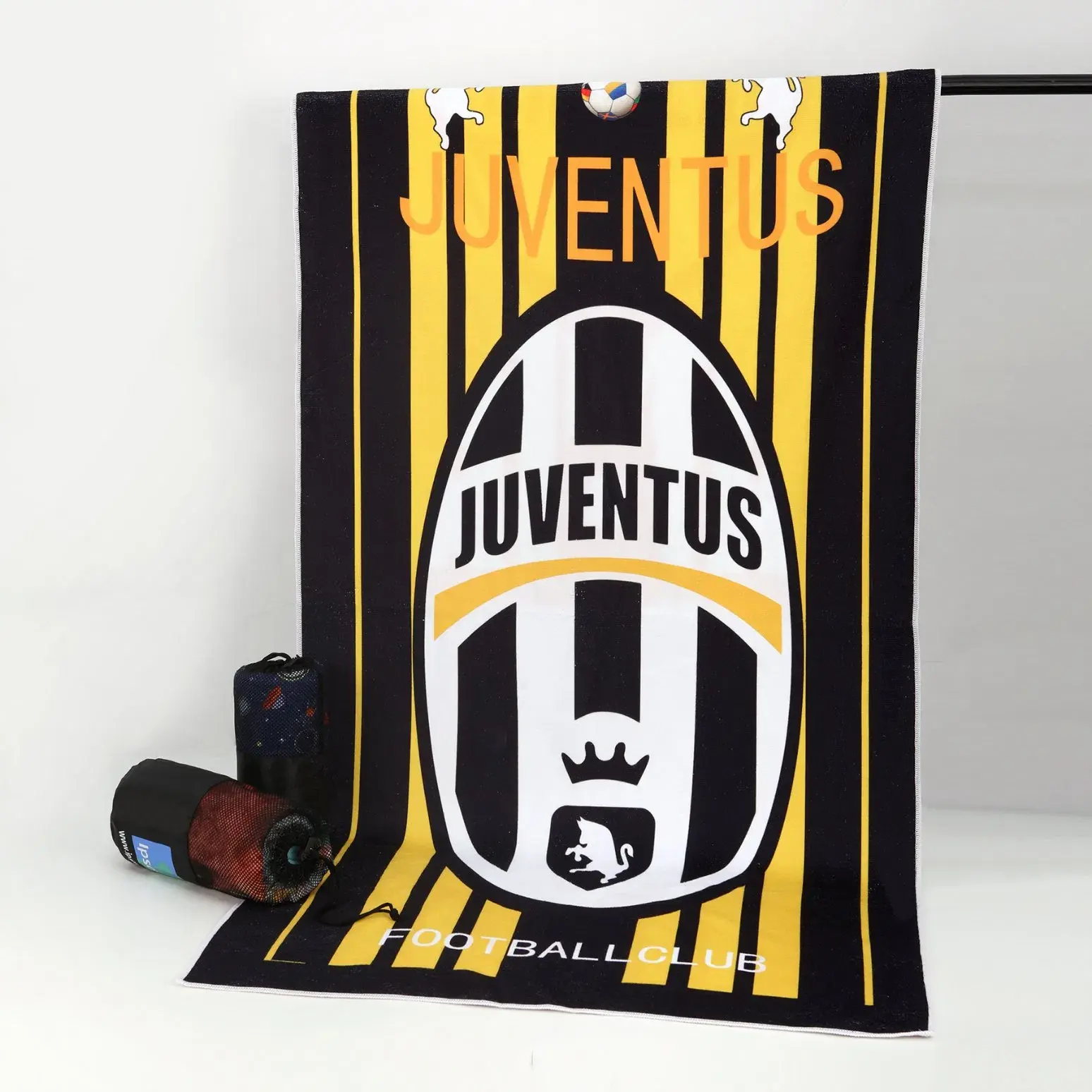 Black and yellow beach towel with a large soccer club crest and lettering.