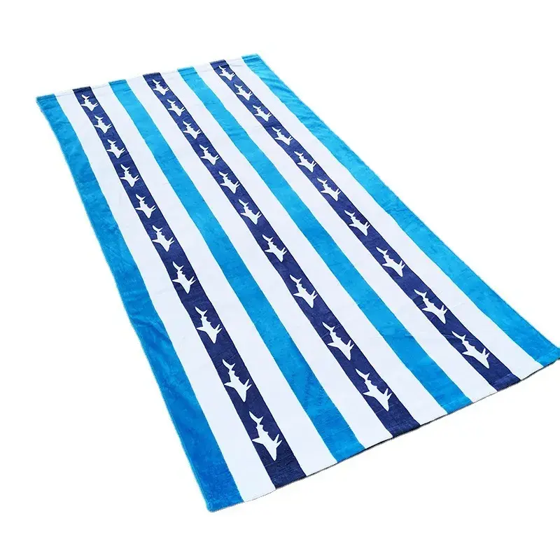Blue and white striped beach towel with rows of white shark silhouettes laid flat.