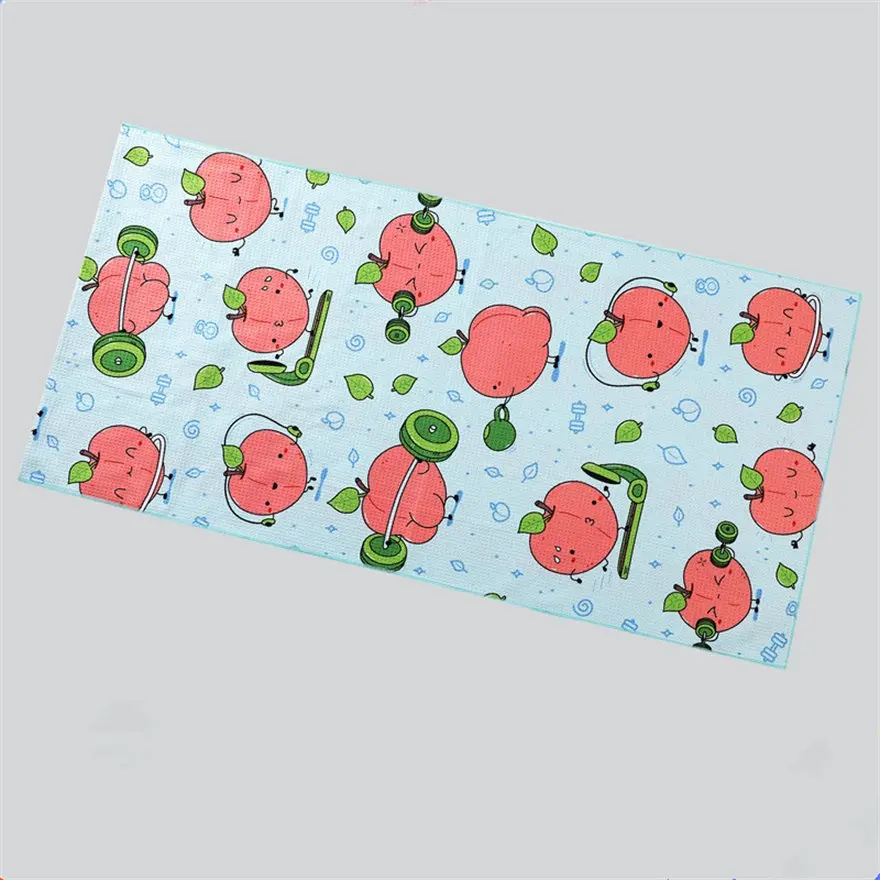 Light blue beach towel with red cartoon apples, green leaves and exercise-themed illustrations.