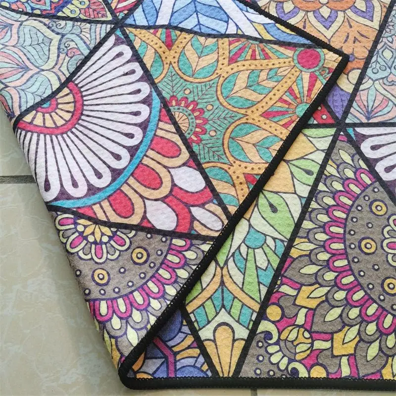 Close-up of a folded corner showing colorful geometric mandala patterns and black stitched edging.