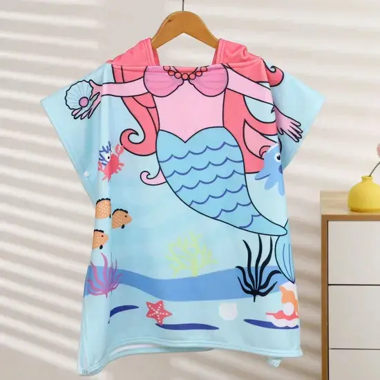 Light blue hooded beach towel with a pink-haired mermaid print hanging from a wooden hanger.