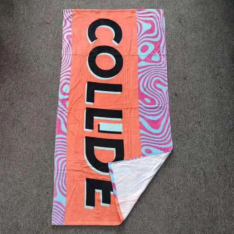 Orange beach towel with bold black lettering, pink and aqua wavy borders and a folded white reverse.