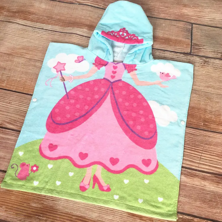 Light blue hooded poncho towel with a pink princess dress, crown on the hood, star wand, clouds and green grass.