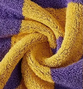 Close-up of purple and yellow towel fabric showing its looped surface texture.