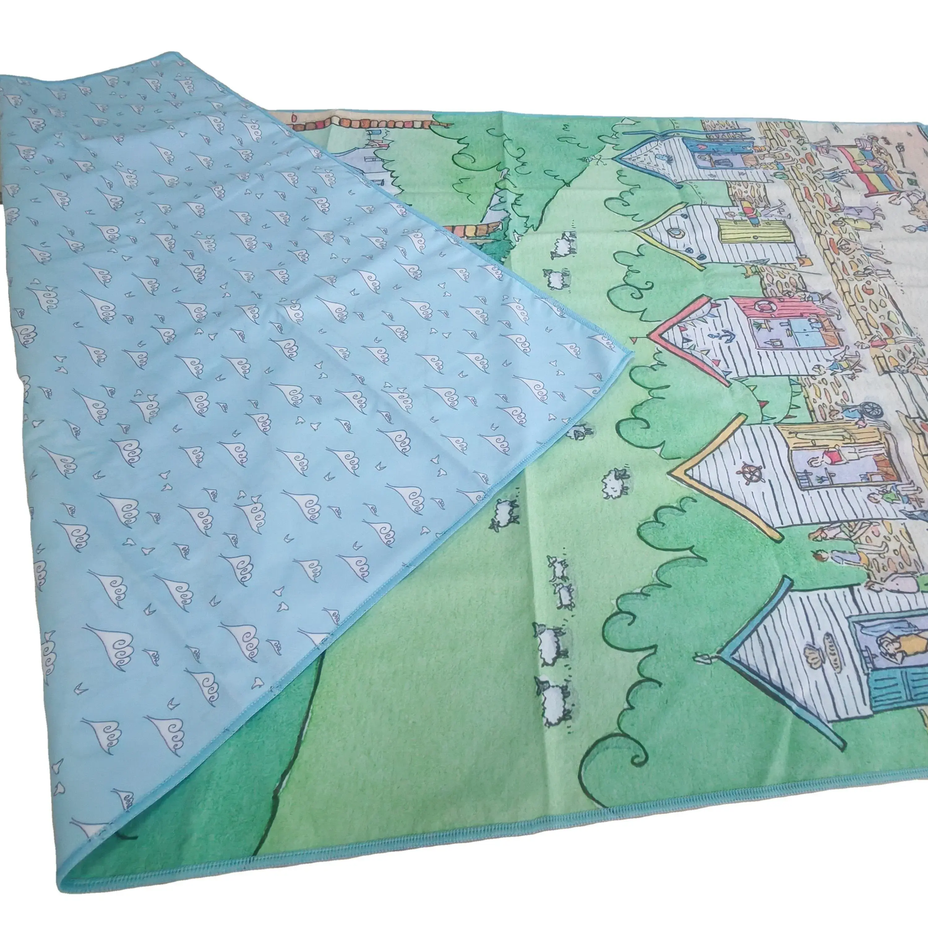 Seaside illustration beach towel with a corner folded back to show a light blue reverse patterned with small white motifs and blue stitched edging.