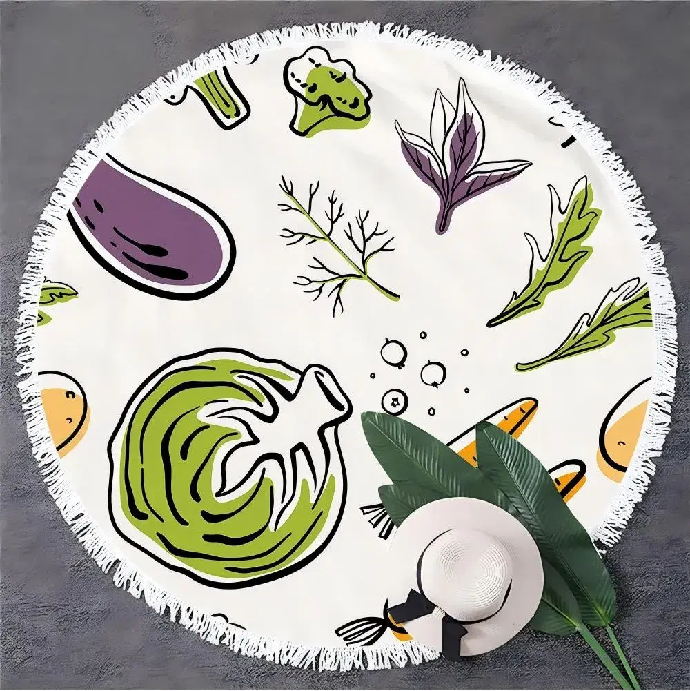 White round beach towel with colorful vegetable illustrations and white fringe, displayed with a hat and green leaves.