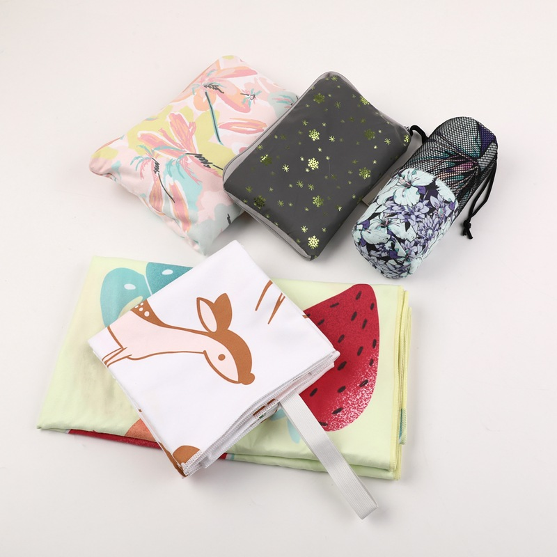 Rabbit- and watermelon-print towels beside printed zippered pouches and a mesh drawstring bag.